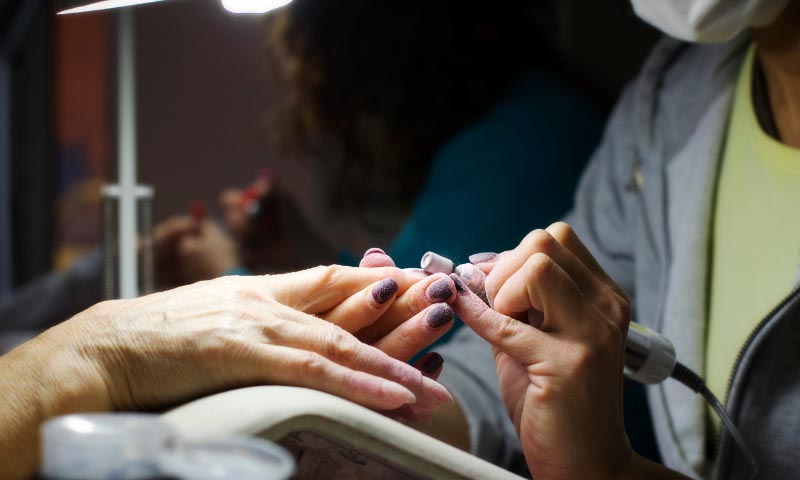 Nail technician working on a customers nails