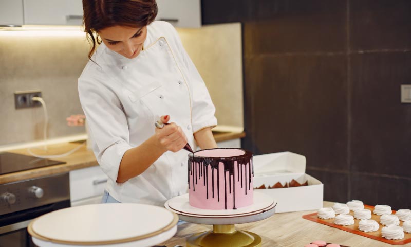 A student decorating an artisan cake