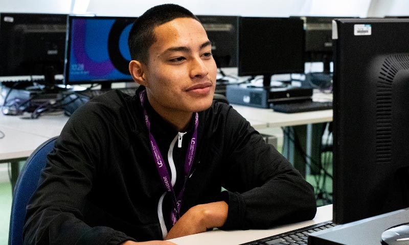 Student sitting at a computer workstation